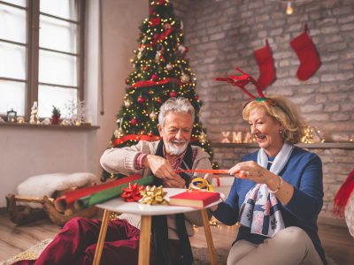 Elderly couple wrapping Christmas presents